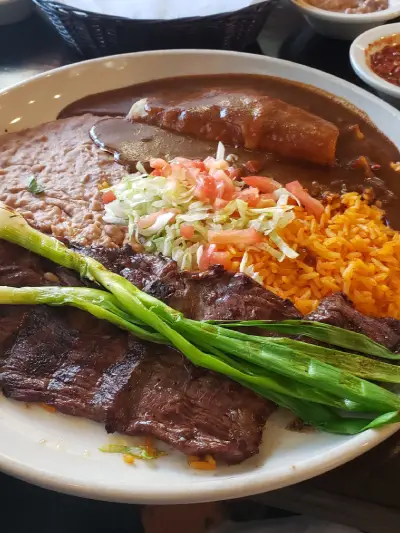 Traditional Mexican mole with rice served at Mexican Real Fam Restaurant – rich, savory, and homemade flavor